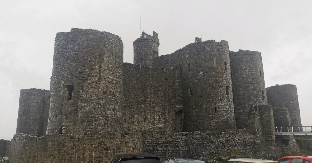 The view of the high thick walls and imposing towers of Harlech Castle.